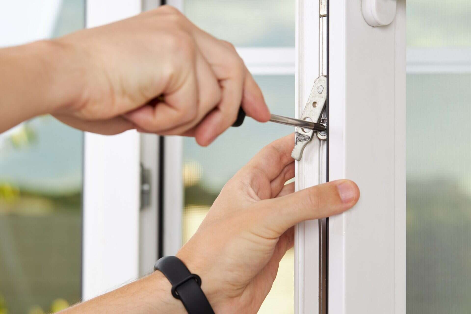 Installer installing new window lock